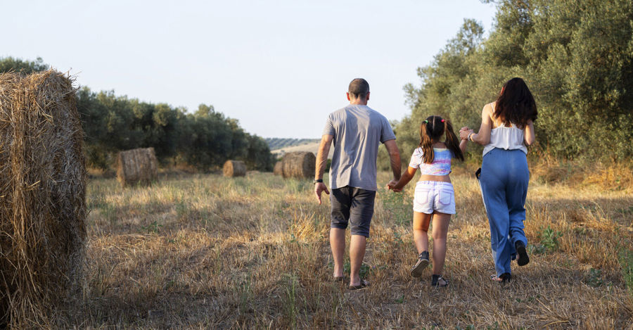 Photo of Andrea walking with his family. Andrea uses Peristeen Plus to help manage his bowel issues. 