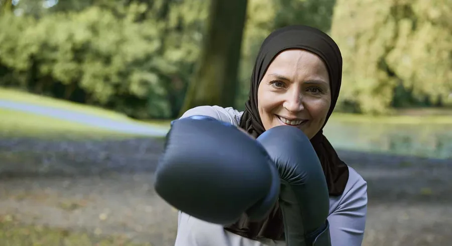 Image of Fikria outside with boxing gloves. Fikria uses Peristeen Light. 