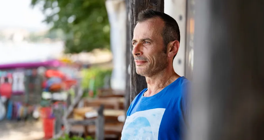 Portrait photo of Andrea outside. Intermittent catheterisation includes a process of learning, and over time, Andrea learned how to catheterise whilst out and about and developed his own personalised routine which suited his needs. 