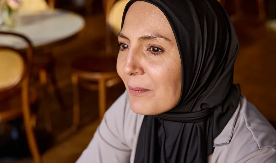 Photo of Fikra in café. Fikria’s bowel issues can be largely attributed to her MS, and it took its toll on her quality of life. 